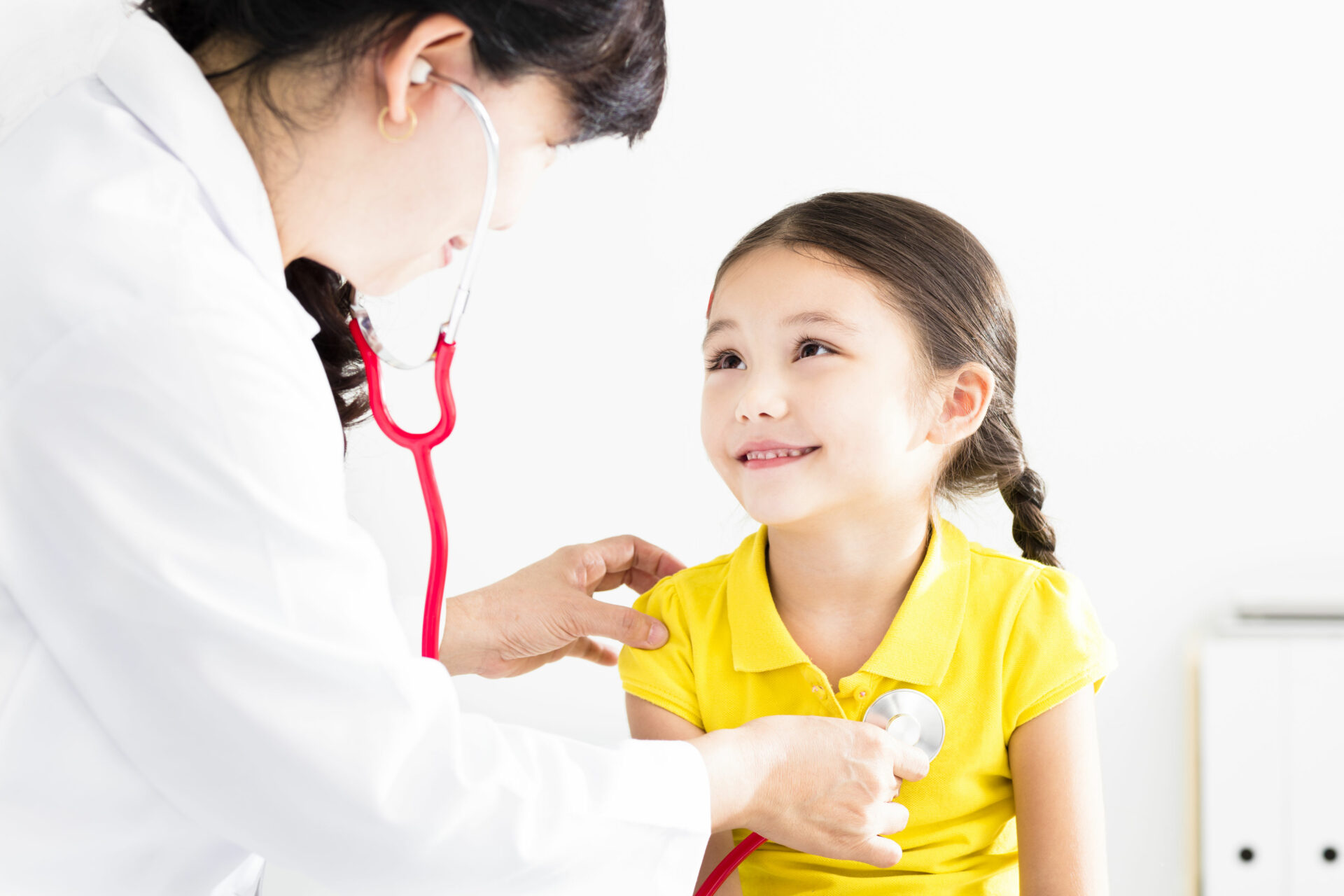 83549542 - female doctor examining  little girl by stethoscope