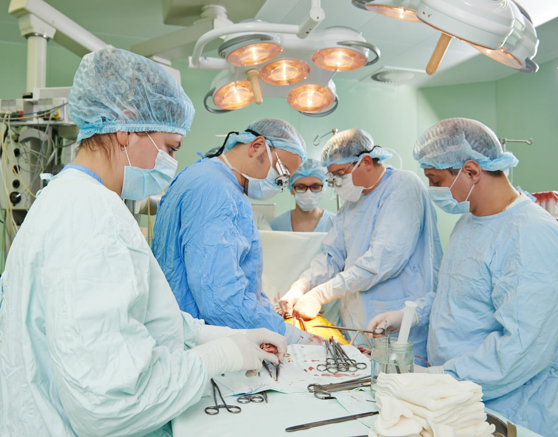 36915604 - team of surgeon in uniform perform heart transplantation operation on a patient at cardiac surgery clinic